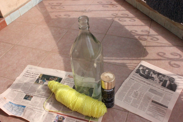 Tools of trade. Bottle, plastic rope, gold spray paint